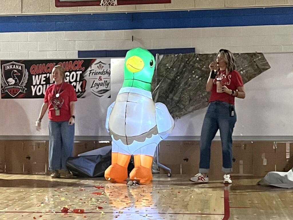 Photo of students and staff participating in house reveal pep rally.