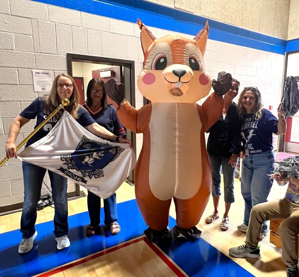 Photo of students and staff participating in house reveal pep rally.