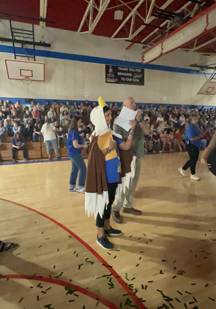 Photo of students and staff participating in house reveal pep rally.