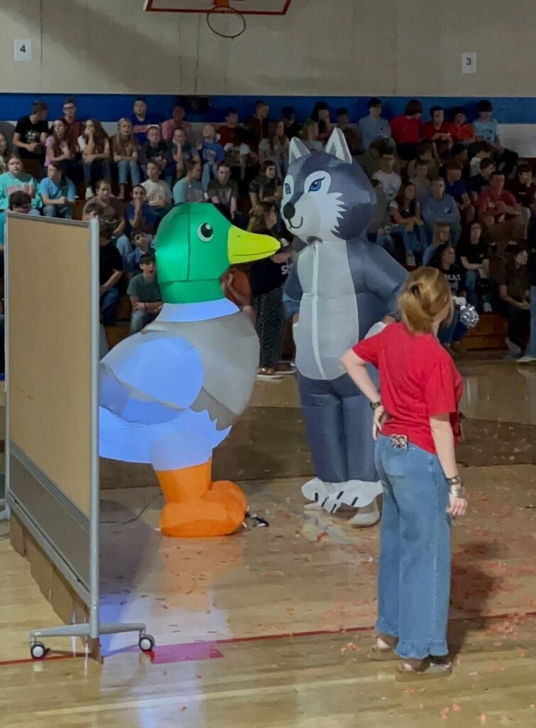 Photo of students and staff participating in house reveal pep rally.