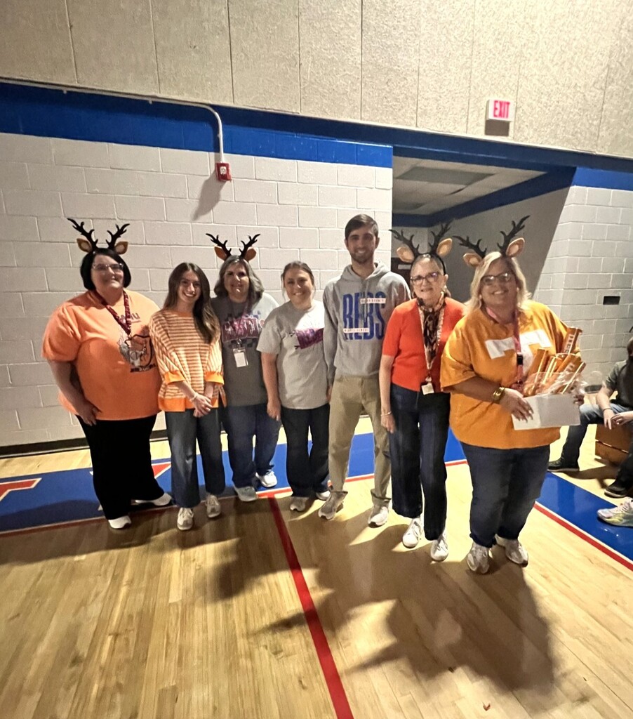 Photo of students and staff participating in house reveal pep rally.