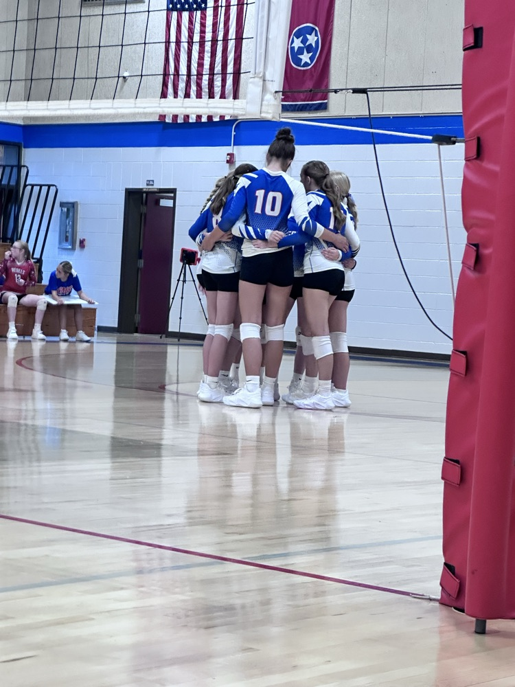 OCMS volleyball players in the huddle