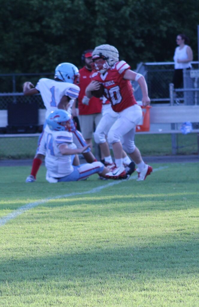 South Fulton Middle School football player avoids being tackled to break away from the defense during football game.