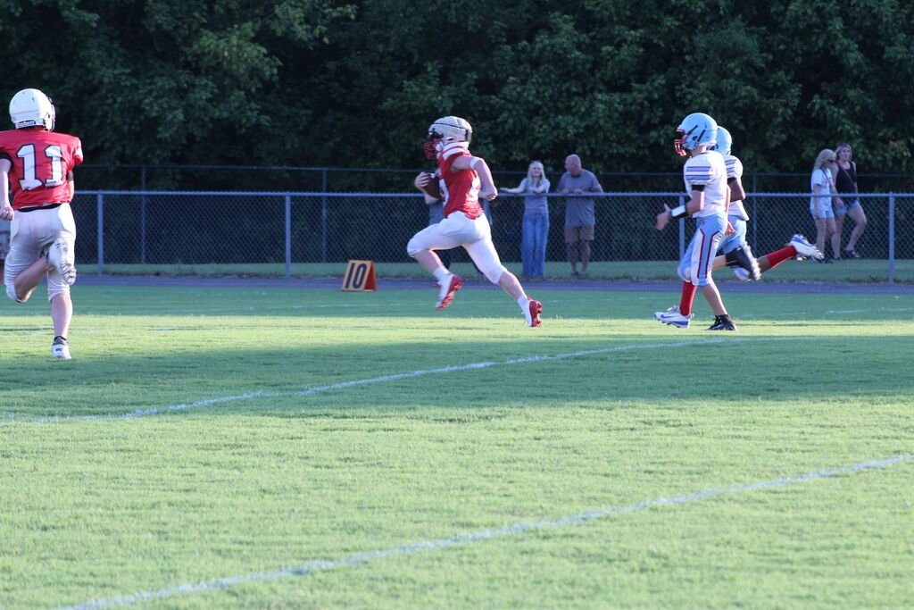 South Fulton Middle School football player breaks away from the defense to score a touchdown during a football game.