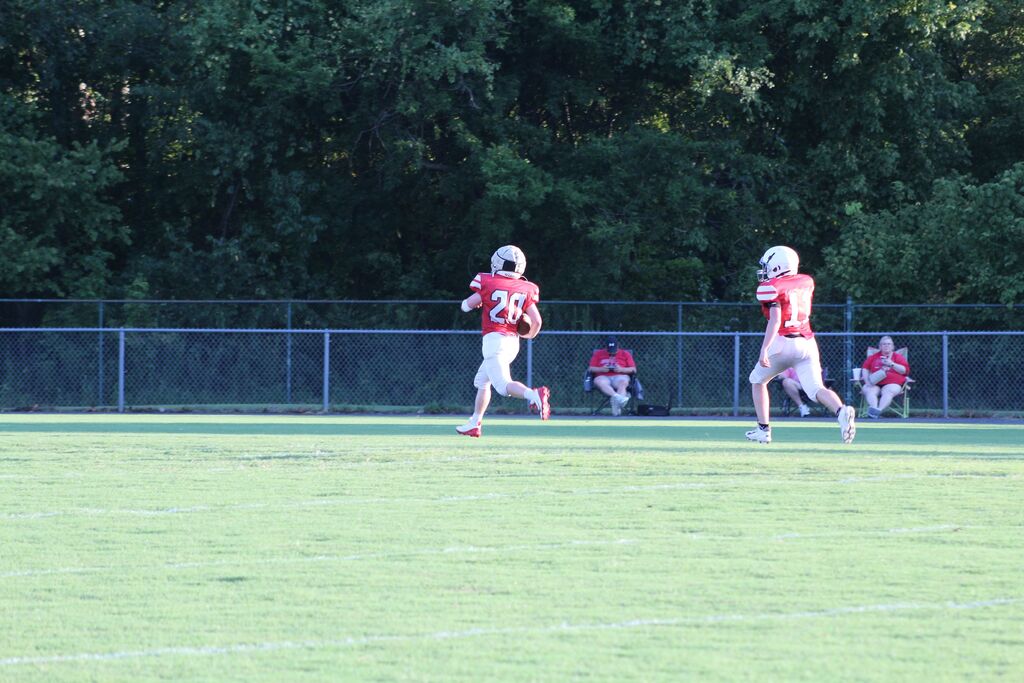 Two South Fulton Middle School football players run the football for a touchdown during a football game.