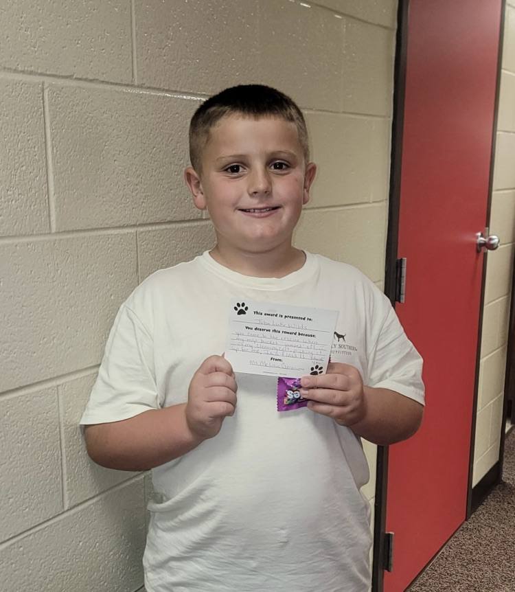 student portrait holding a card 