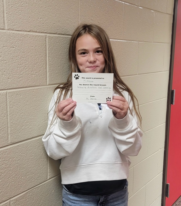 student portrait holding a card 