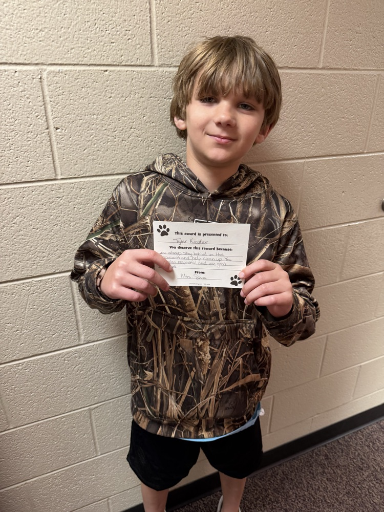 student portrait holding a card 