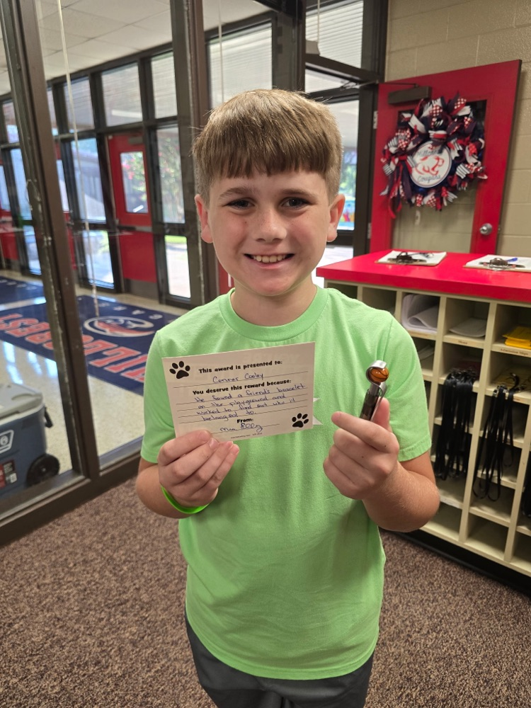 student portrait holding a card 