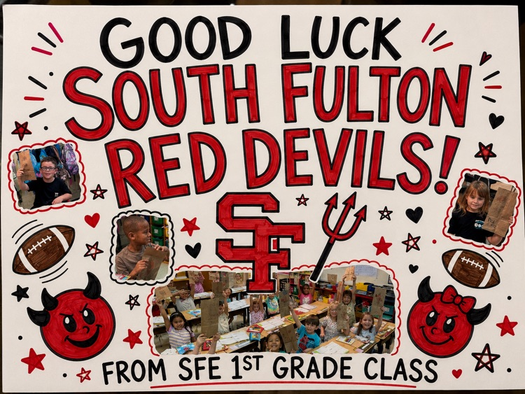 students pictured with good luck art for football team