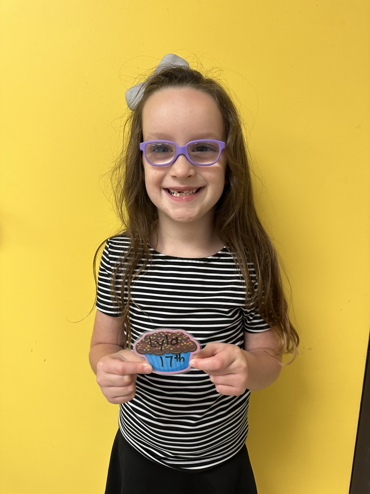 Lyla Baker holding her cupcake picture. 