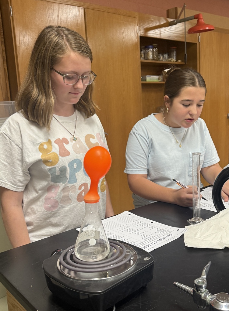 Students in Ms. Demanda’s 7th-grade science class participate in several hands-on experiments exploring states of matter and gas laws. Photos show students working together at lab stations with bottles, balloons, glassware, water, heat, and other classroom science materials while recording and observing their results.