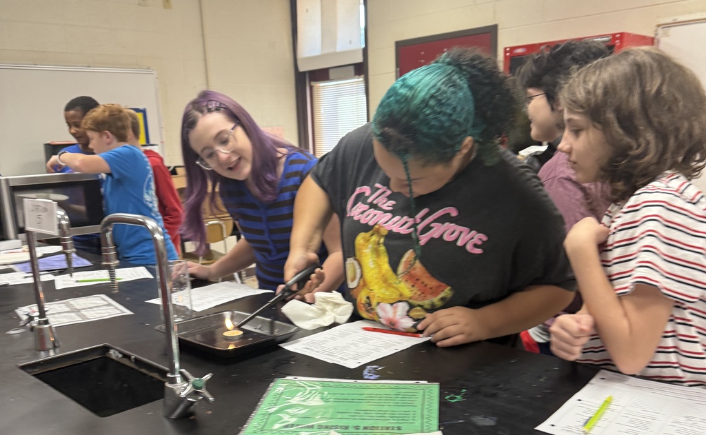 Students in Ms. Demanda’s 7th-grade science class participate in several hands-on experiments exploring states of matter and gas laws. Photos show students working together at lab stations with bottles, balloons, glassware, water, heat, and other classroom science materials while recording and observing their results.