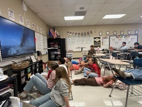 Students watch historical footage about September 11 as part of their Article of the Week lesson.