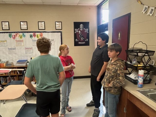 Students work together in a small group to discuss choices and possible responses to their scenario.