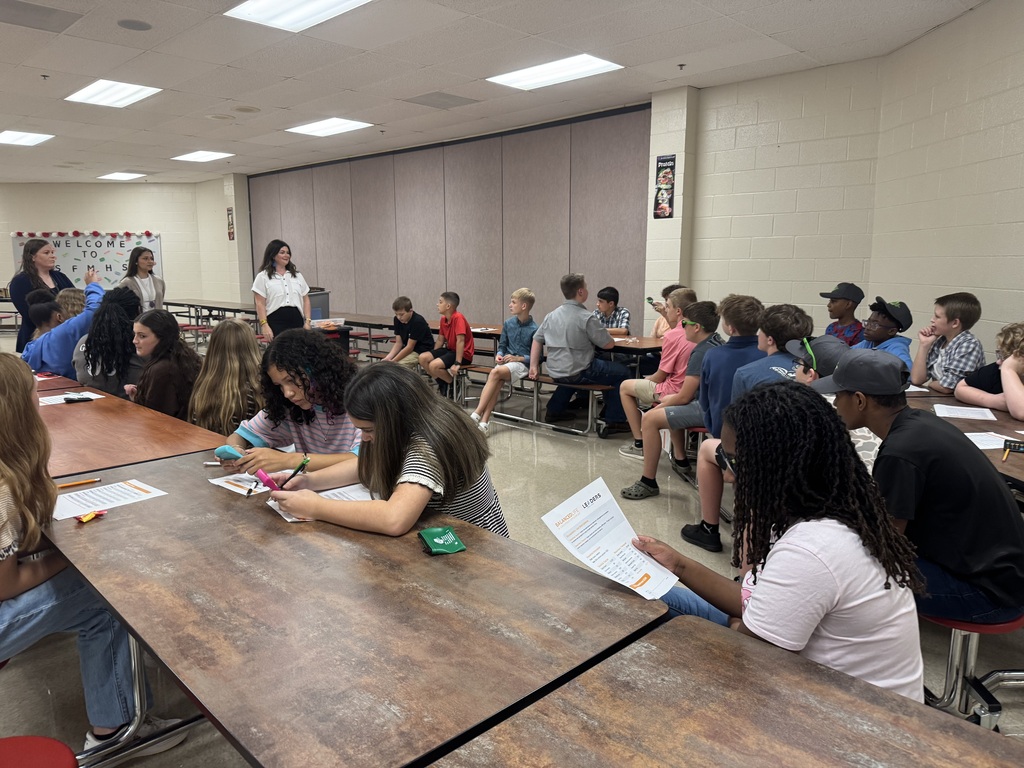 Students work together during South Fulton Middle School’s Financial Fair, completing budgeting activities and making financial decisions at tables throughout the cafeteria. Teachers and facilitators guide the students through the hands-on financial literacy exercise.