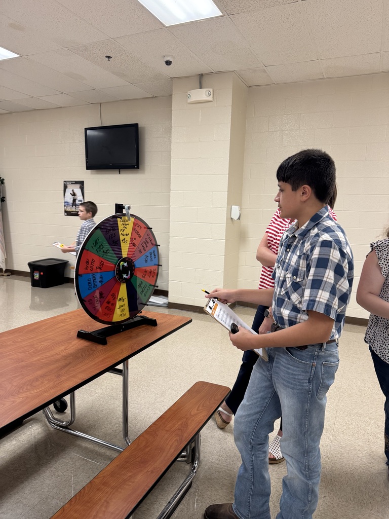 A South Fulton Middle School student participates in the Financial Fair by spinning a prize wheel while recording information on a clipboard. The activity gives students a hands-on opportunity to make financial decisions and practice budgeting skills.