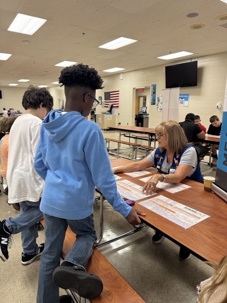 A South Fulton Middle School student participates in the Financial Fair by working with a facilitator at a budgeting station. The student reviews financial information and makes decisions as part of the hands-on financial literacy activity.