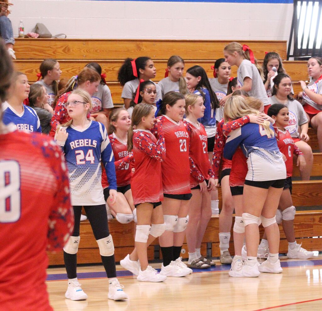OCMS Volleyball players gather and congratulate 8th grade players before game.