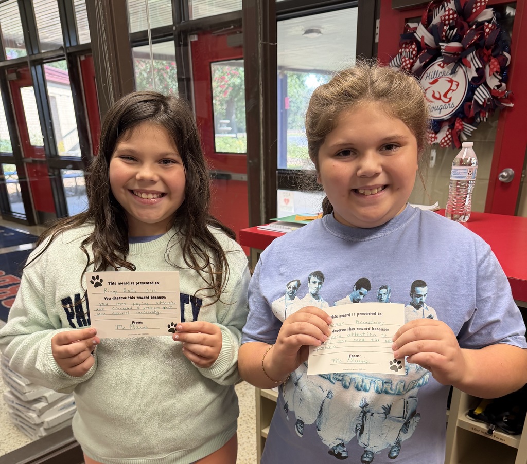 two students holding their cards