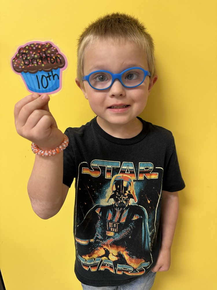 Britton holding his birthday cupcake cutout. 