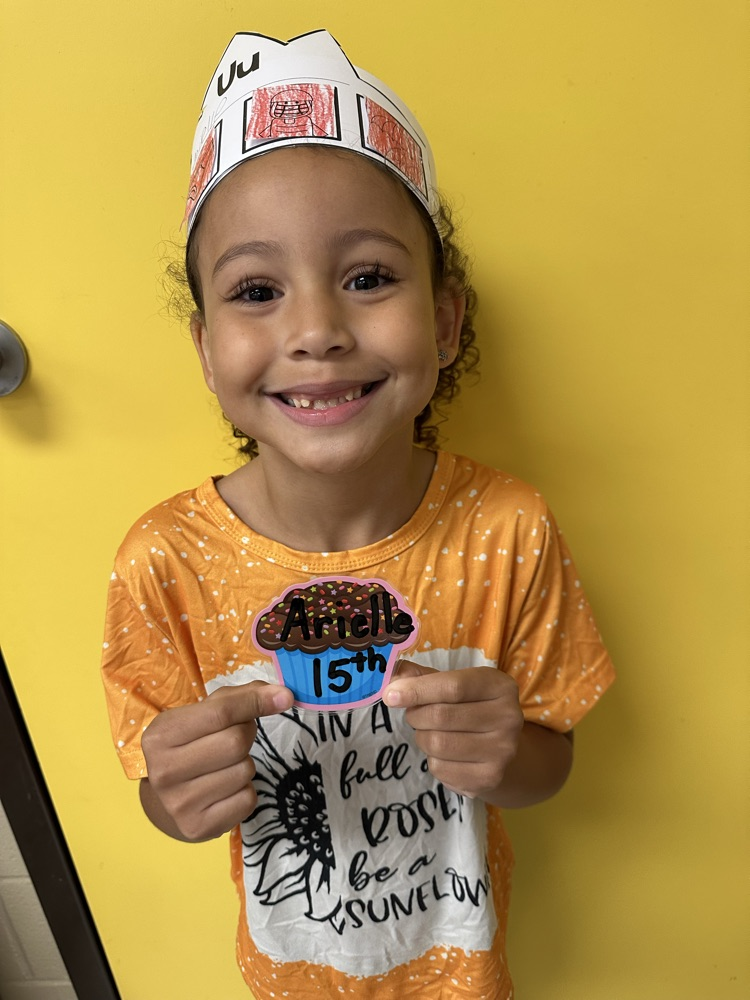 Arielle holding her birthday cupcake cutout. 