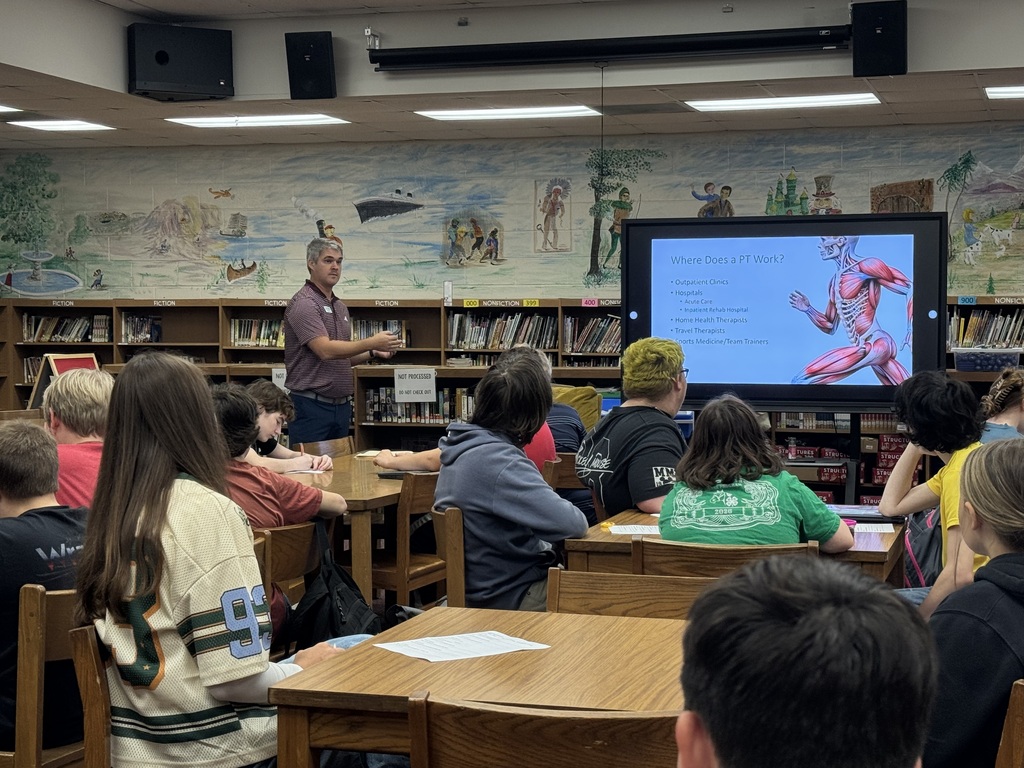 OCMS students listen as a guest speaker discusses physical therapy careers during a classroom presentation.