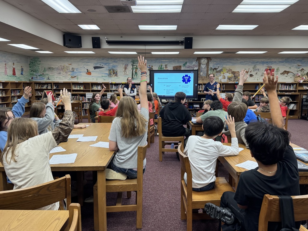 Many OCMS students eagerly raise their hands during an interactive discussion with UTM nursing students about nursing education and careers.