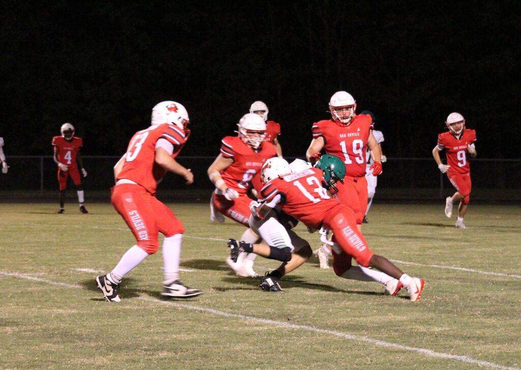 A group of South Fulton football players tackle a Ballard County player with the football.