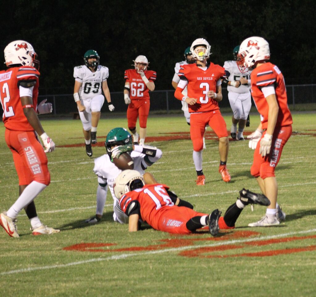 A South Fulton football player tackles a Ballard County football player while other teammates watch.