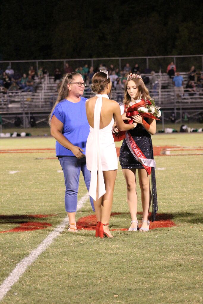 A new homecoming queen is crowned on the football field during halftime.