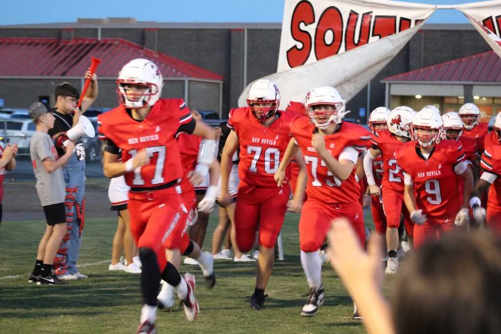 South Fulton Red Devil football players run through the spirit sign before football game.