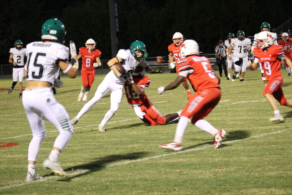A Ballard County football player is tackled by several members of the South Fulton football team.