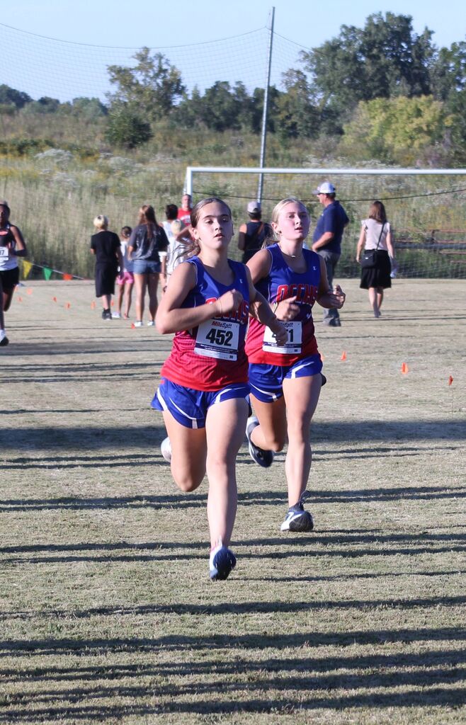 A pair of OCCHS Girls' Cross-Country runners completing the race.