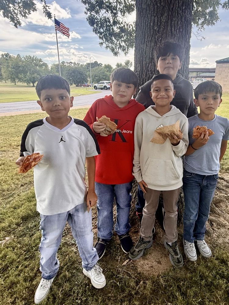 students holding their pizza 