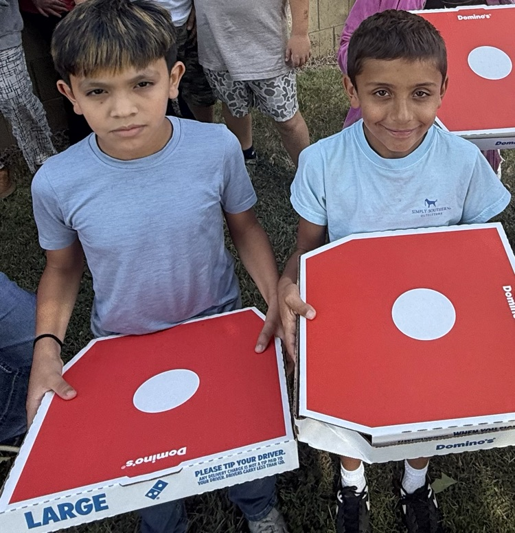 students holding Dominoes pizza boxes 