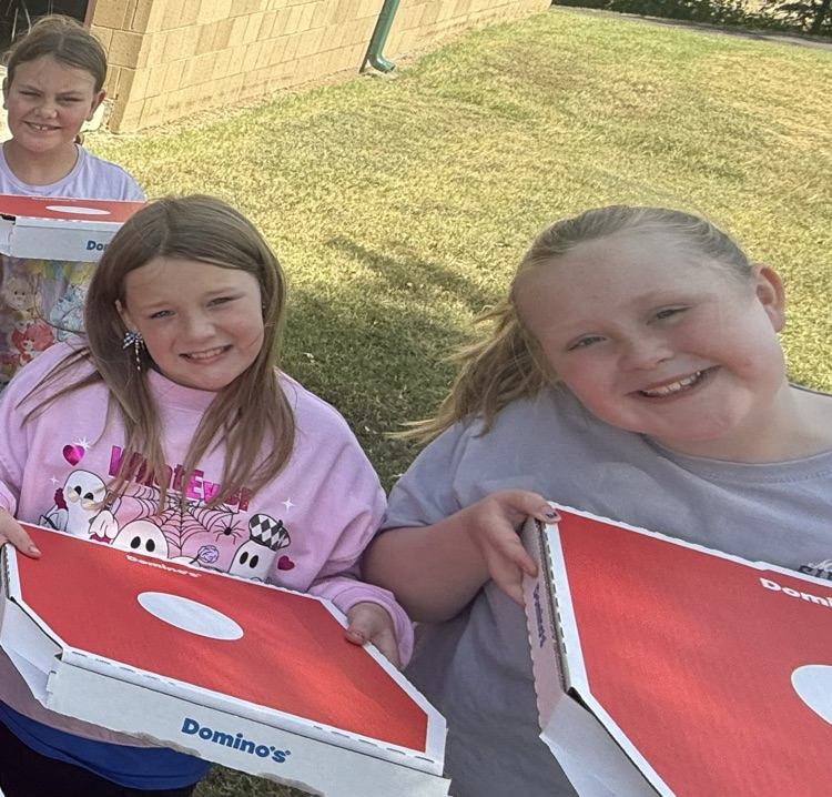 two girls holding Dominoes pizza boxes 