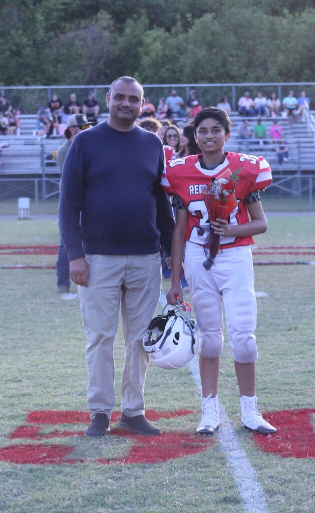 A SFMS football player smiles with his Dad.