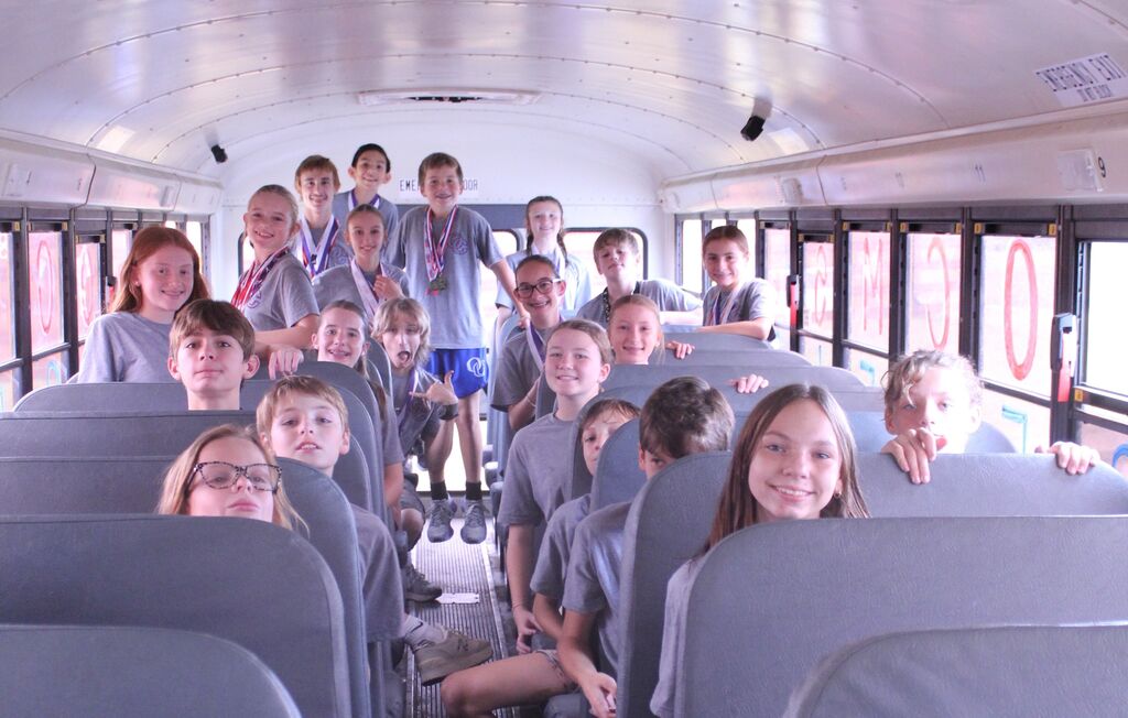 Cross Country runners on bus to go to state.