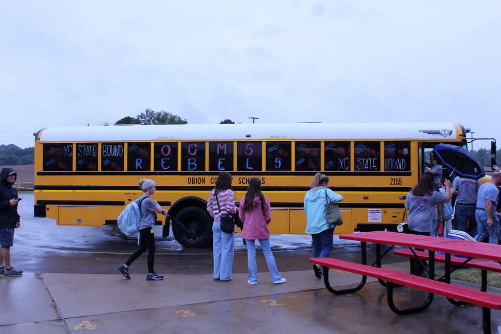 A decorated school bus waiting for runners to board.