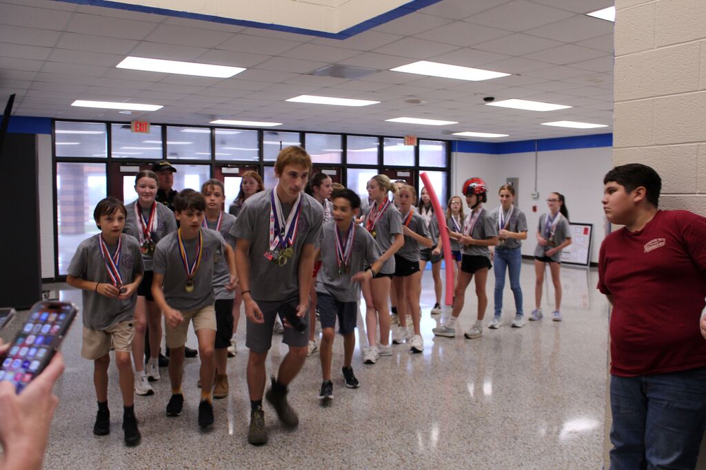 The OCMS Cross Country team lined up to run the hallways.