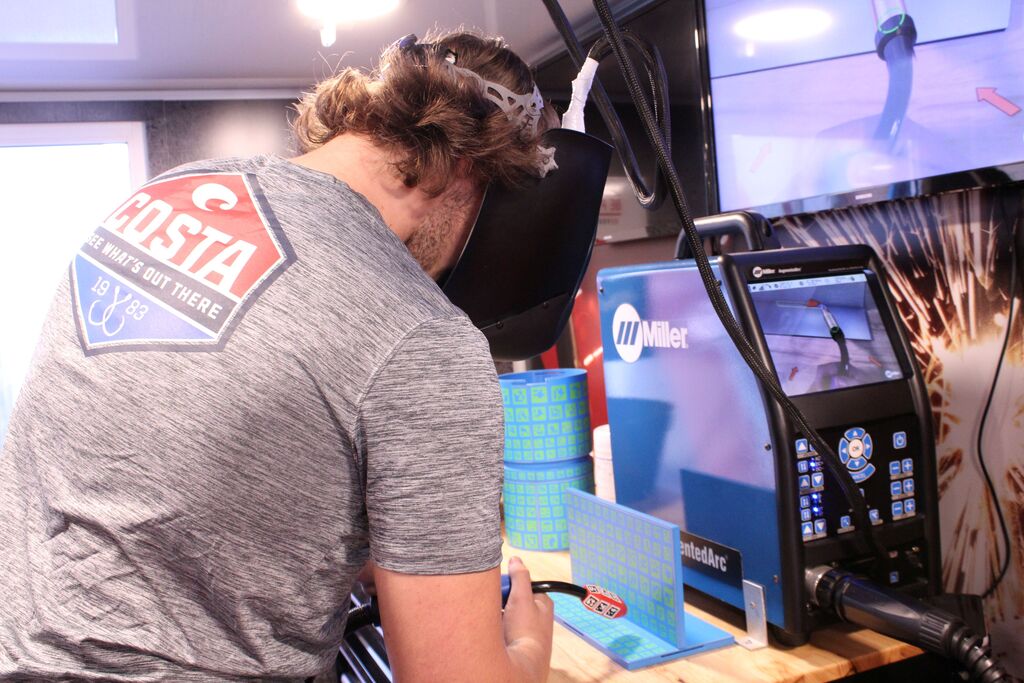 An OCCHS student tries his hand at the welding simulator.