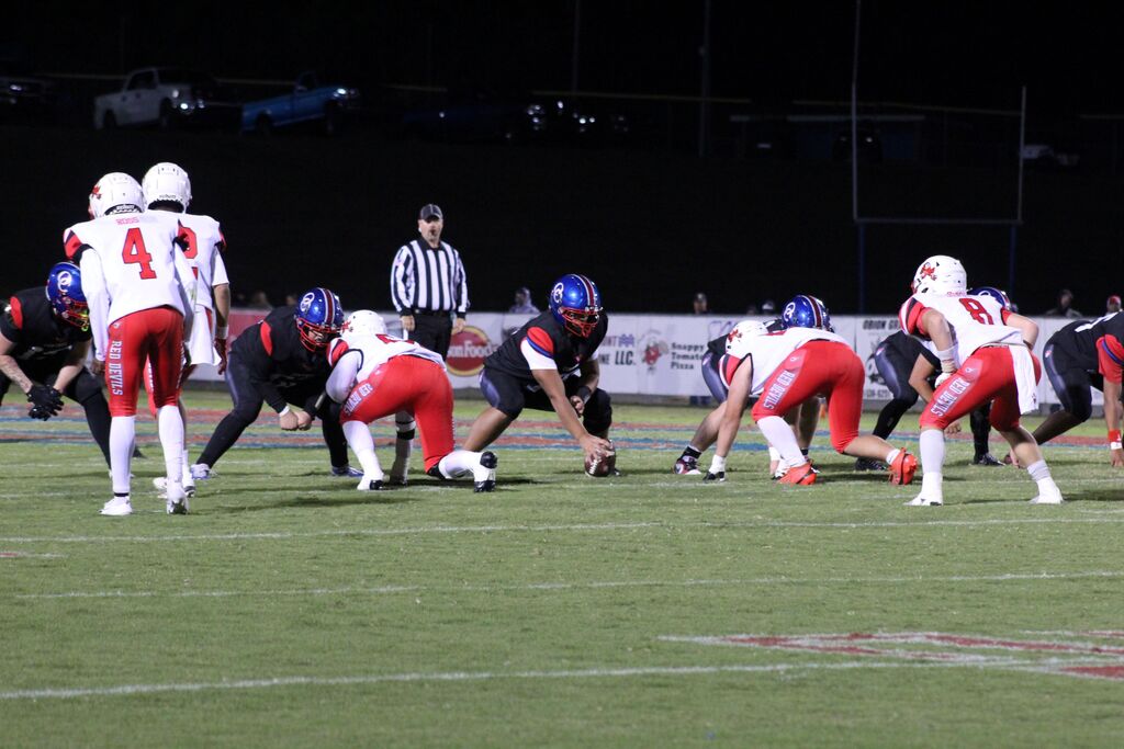 OCCHS and SFHS Football players line up to play during the homecoming football game.