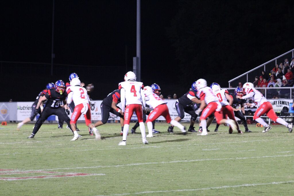 OCCHS and SFHS football players line up to play in the homecoming football game.