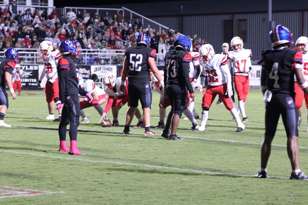 SFHS football team prepares to snap the ball while OCCHS football players line up in defense.
