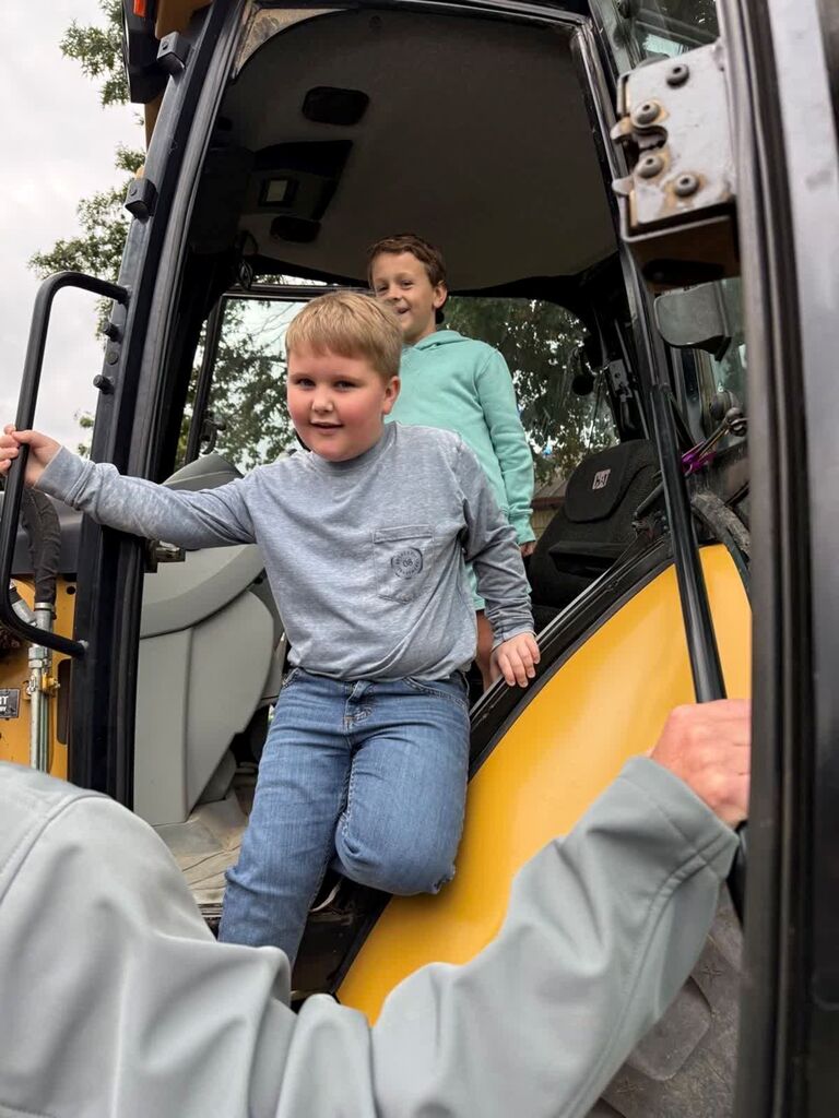 Two Hillcrest students climb out of a tractor at Careers on Wheels.