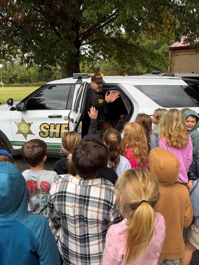 A group of Hillcrest students gather and listen to a Sheriff's Deputy at Careers on Wheels.