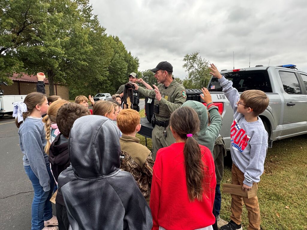 A group of Hillcrest students gather and listen to a TWRA officer at Careers on Wheels.