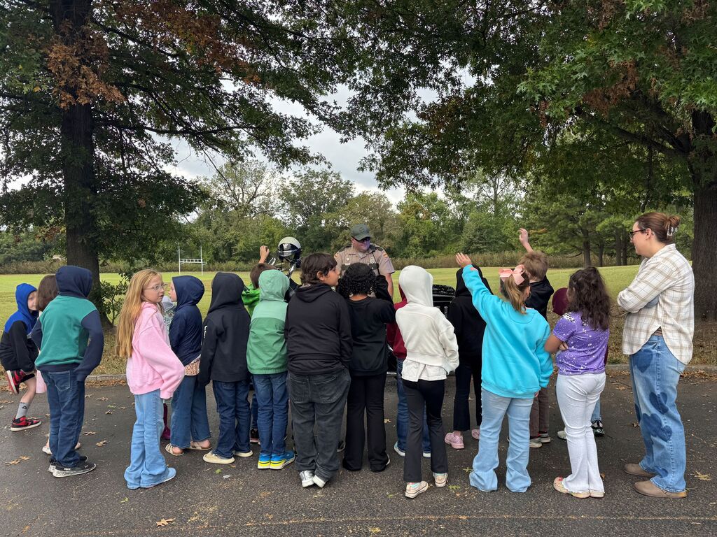 A group of students gather and listen to a Tennessee Highway Patrol officer at Careers on Wheels.