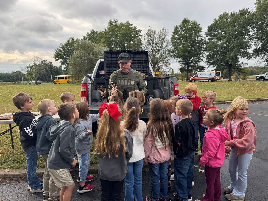A group of Hillcrest students gather and listen to a TWRA officer at Careers on Wheels.